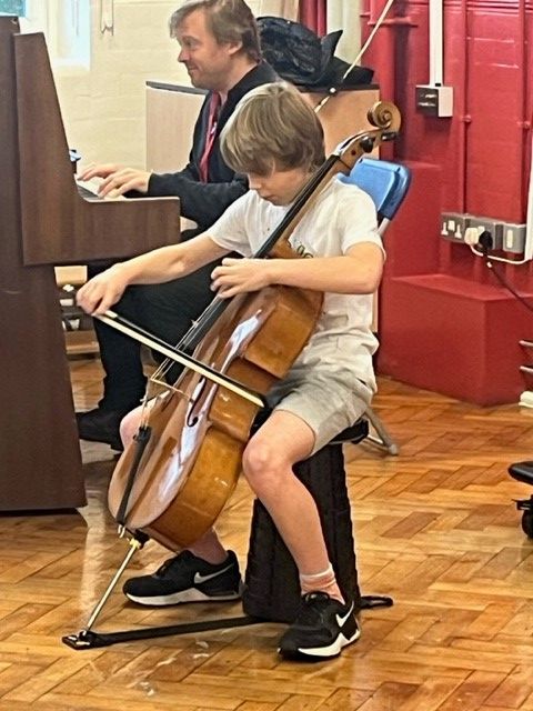 Photo of Elliot playing cello